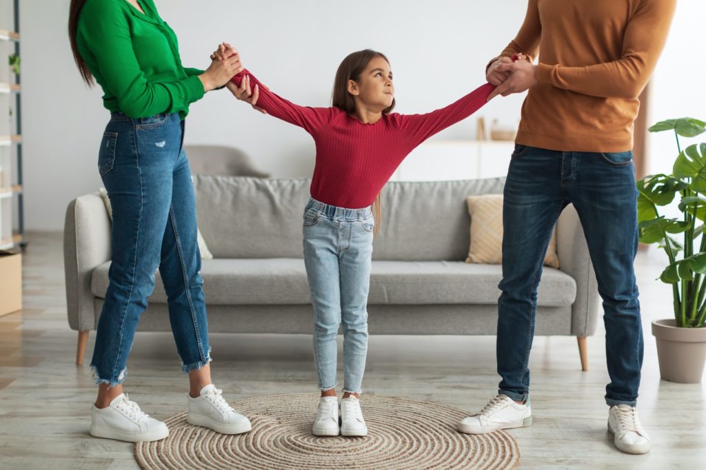 Divorce. Angry parents fighting over their child